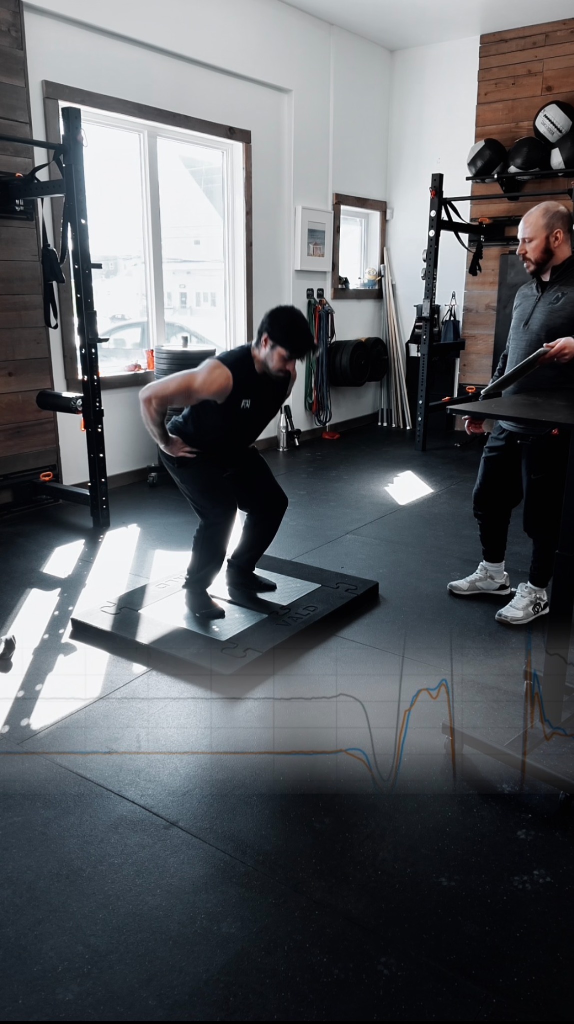 Morgan Campbell coaching an athlete through a gym exercise