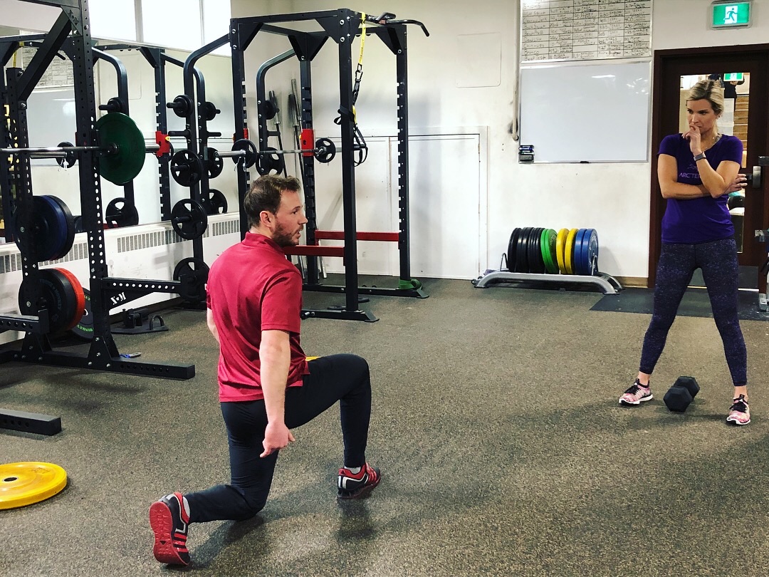 Athlete training in a gym with coaching support