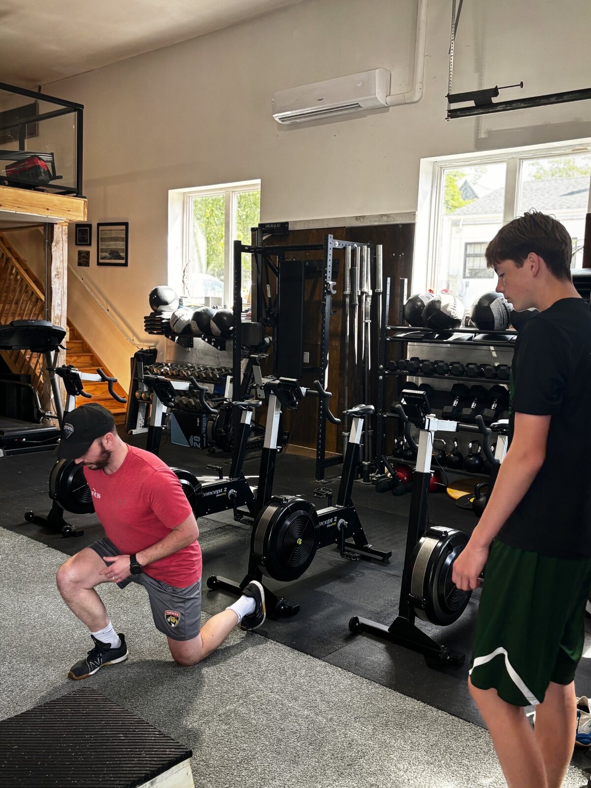 Athletes training in the gym with coaching support