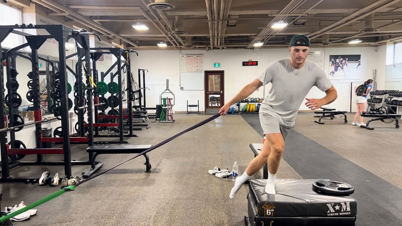 Noah Dobson performing a banded crossover step-up in the performance gym